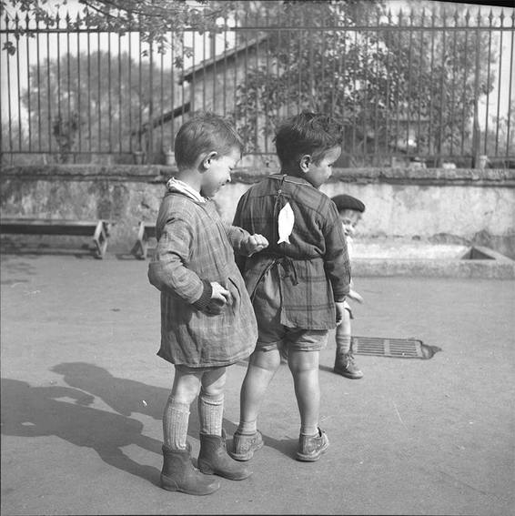 cour de l'école, Poisson d'avril Photo of French school boy putting paper fish on back of his friend