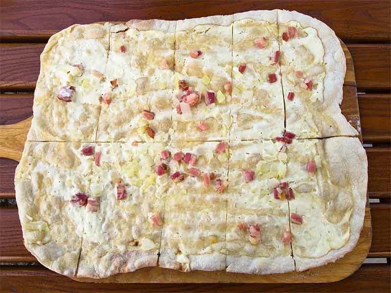Flammkuchen, or Tarte flambée is an Alsatian pizza Flammkuchen, or Tarte flambée is an Alsatian pizza you can easily find at most French Christmas markets