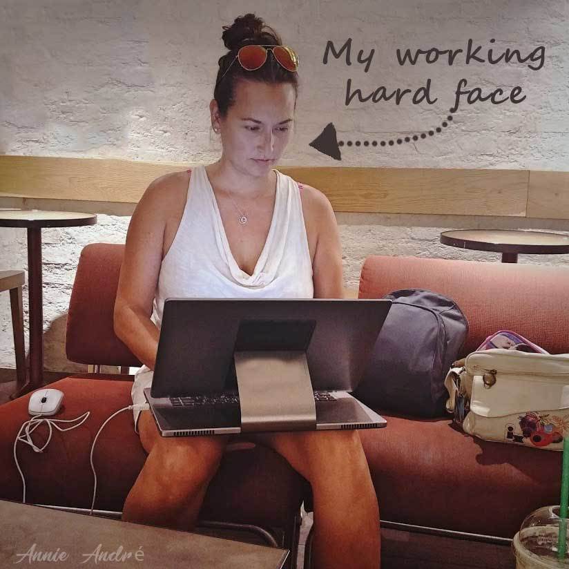 Photo of me, Annie Andre working on computer at a coffee shop