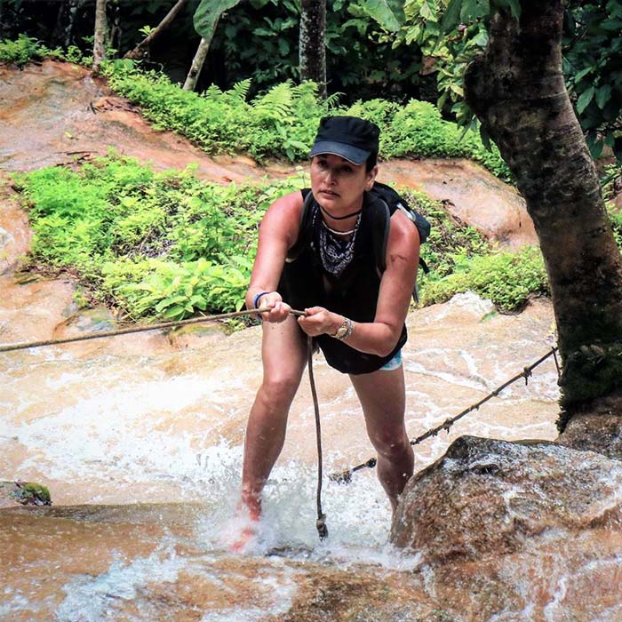 Annie André photo climbing sticky waterfall in Thailand